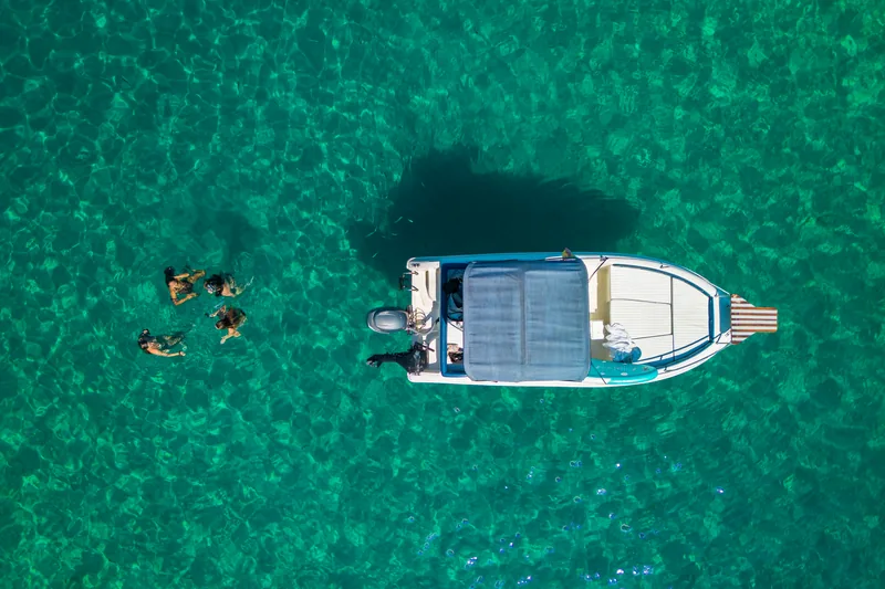 Snorkel junto a la lancha en agua cristalina